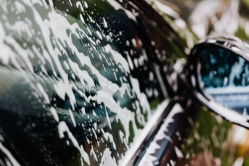 Detailing technician polishing automotive paint